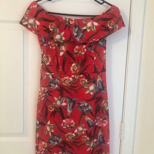 Dress is bright Red with floral print.